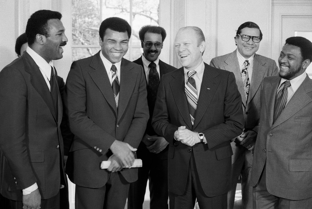 World heavyweight champion Muhammad Ali and his brother Herbert Clay (L) meet with President Ford at the White House. Ali said he liked the White House, and just might go after the job. Ford said there were times he'd be happy to let him have it.