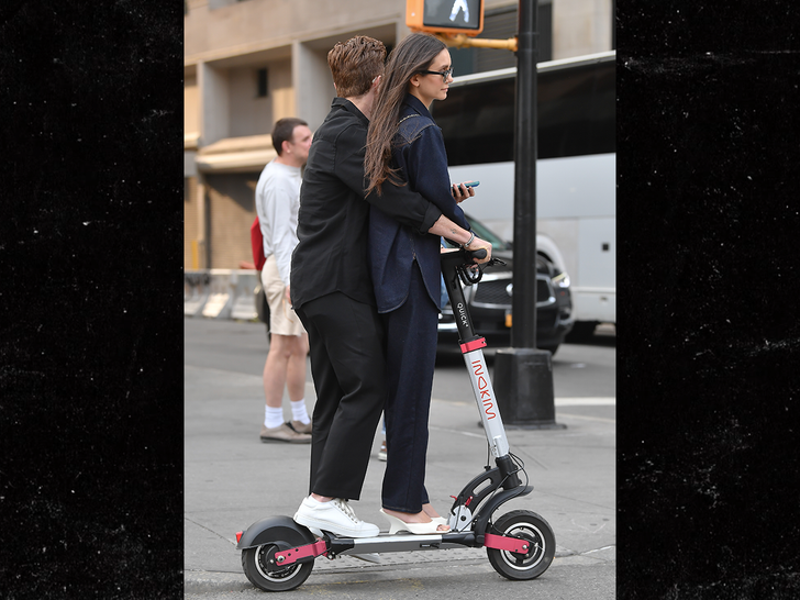 Nina Dobrev and Shaun White ride a scooter