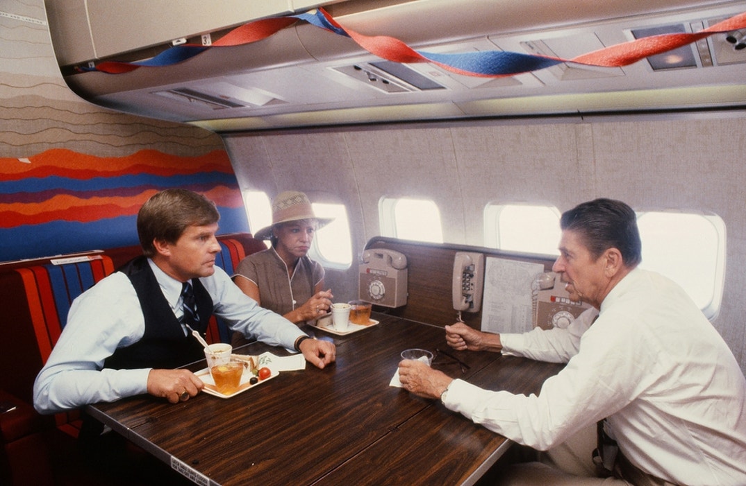 American politian and US President Ronald Reagan talking to one of his aides on board Air Force One, during his re-election campaign, Texas, June 1, 1984.