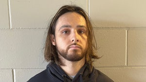 Jonathan Rinderknecht is seen posing for a mugshot. He's wearing a black hoodie.