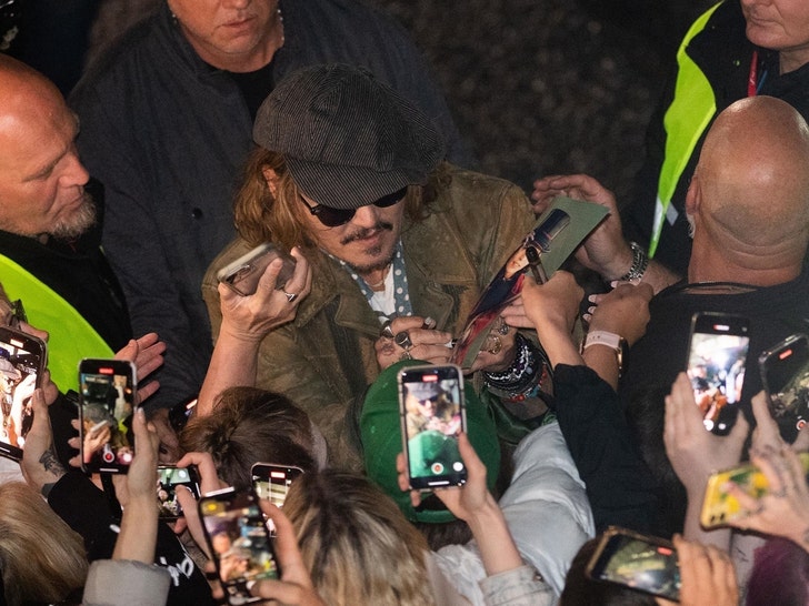 Johnny Depp Swarmed by Fans, Signs Autographs