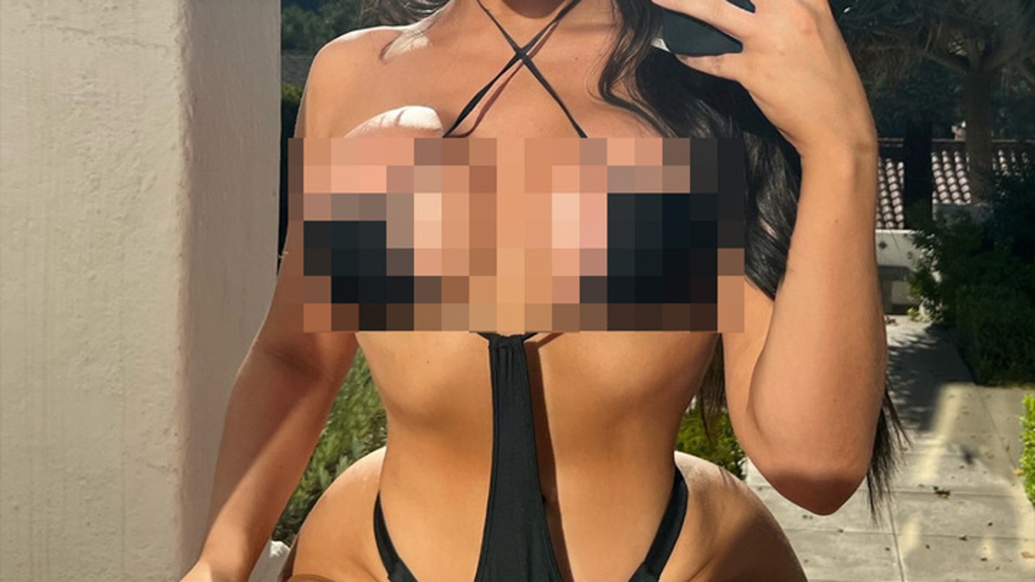Guess the Sexy Star Sportin’ This Black Cut-Out Swimsut!