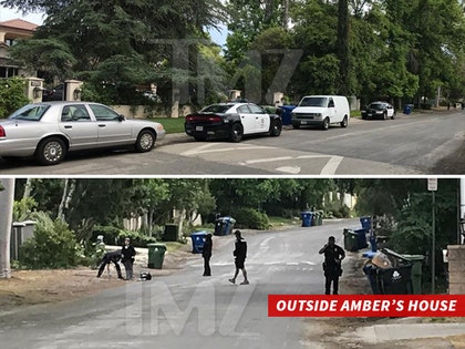 0517_cops_outside_ambers_home_tmz_wm