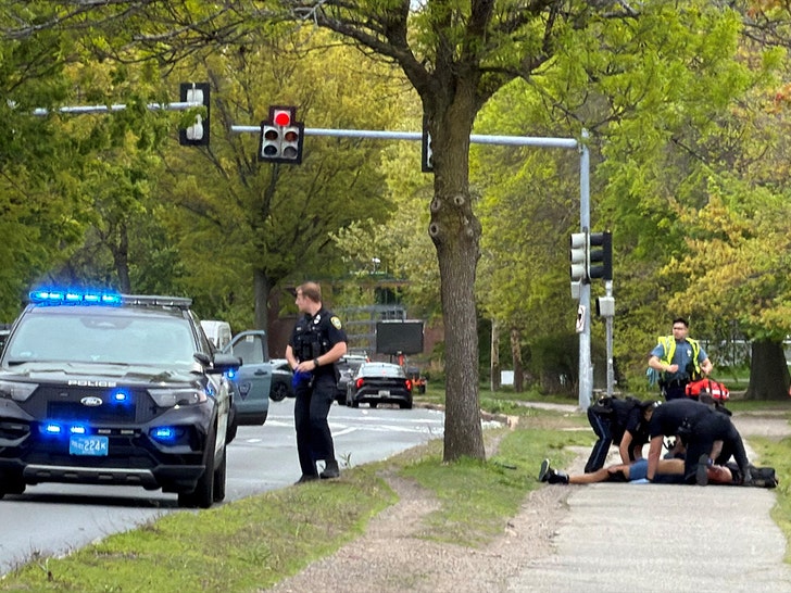 Man who had been seen shooting a weapon along Memorial Drive is treated by police officers in Cambridge reuters 2