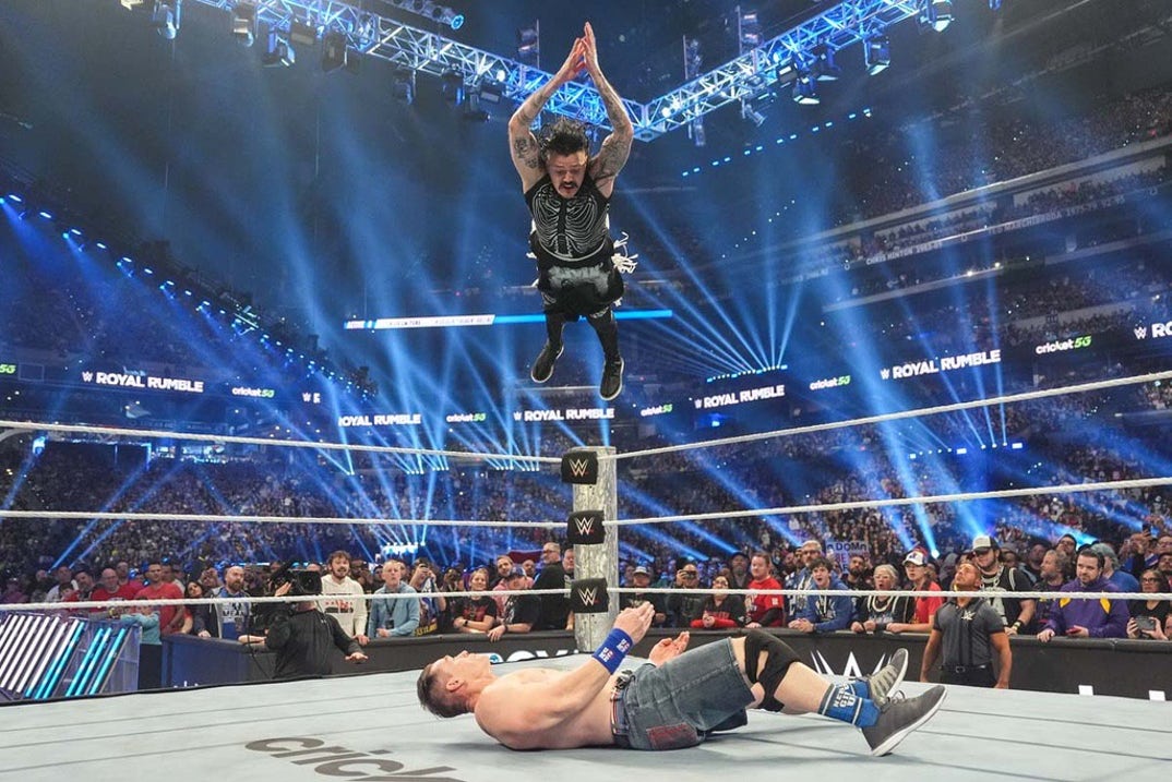 Dominik Mysterio hits a giant frog splash on Cena.