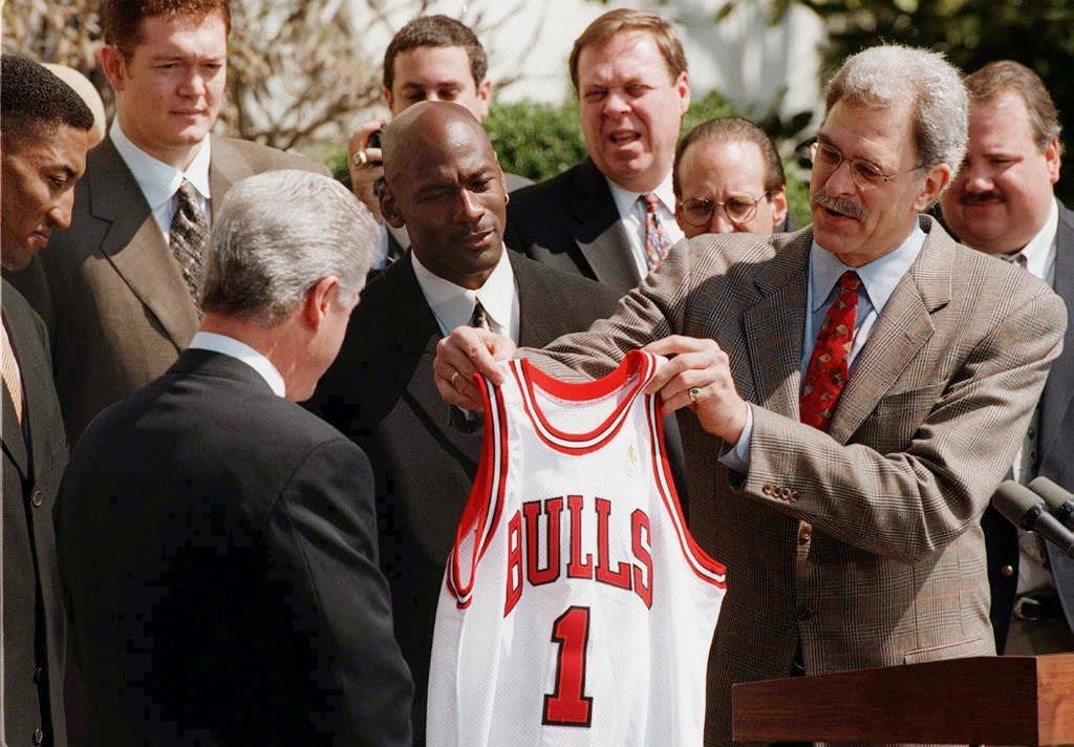 Head coach of the National Basketball Association (NBA) Chicago Bulls basketball team Phil Jackson (R) presents a jersey to US President Bill Clinton (L) in ceremonies 03 April at the White House in Washington. The Bulls were honored as the current champions of the National Basketball Association.