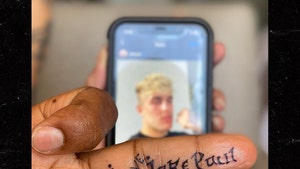Tyron Woodley Gets 'I Love Jake Paul' Tatted On His Middle Finger