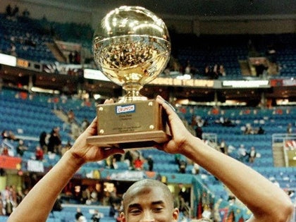 Kobe Bryant shows off his trophy for winning the NBA All-Star Slam Dunk Contest in 1997.