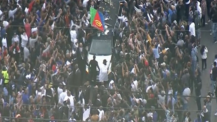 A fan of rapper Nipsey Hussle holds a sign as he attends a public