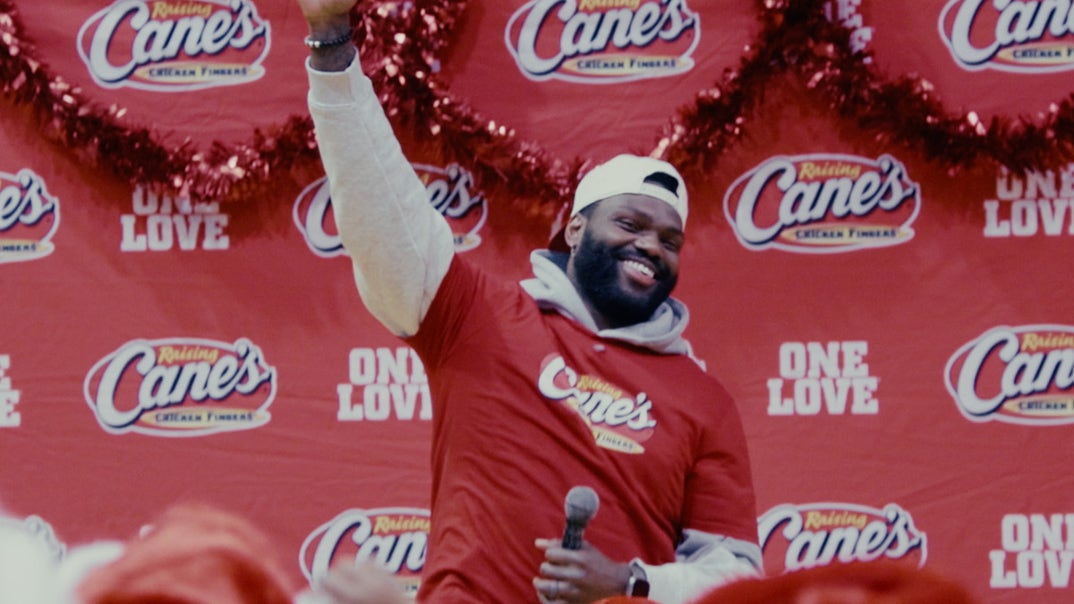 1203-Shaquil-Barrett-With-Raising-Canes-PRIMARY