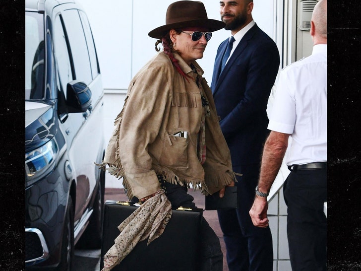 Johnny Depp is All Smiles Boarding Private Jet in Paris.jpg