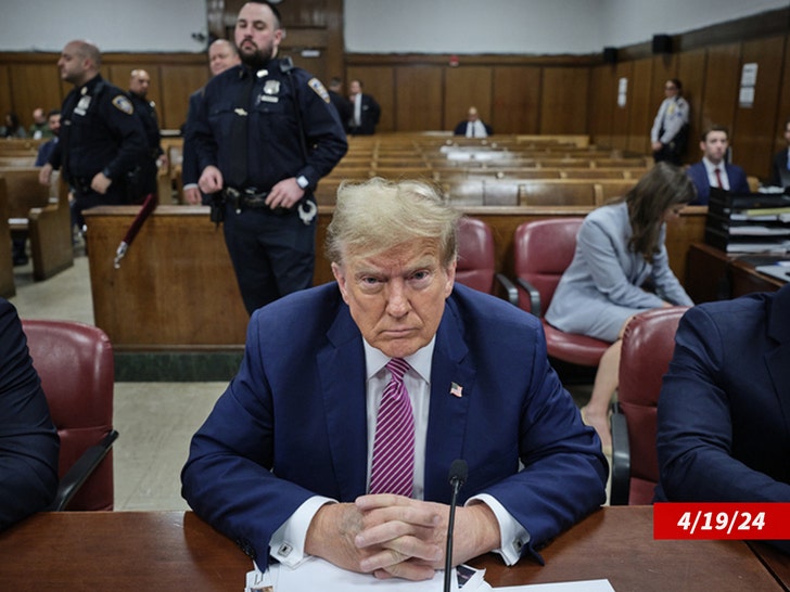 Donald Trump sits at the defendant's table