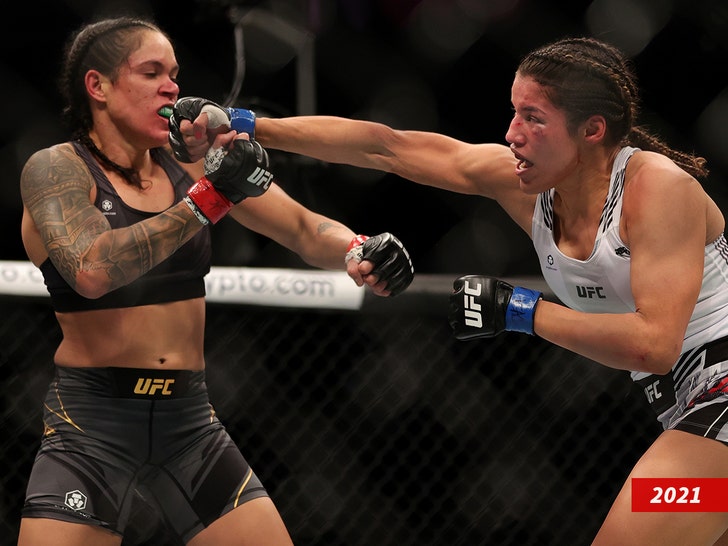Julianna Pena (R) punches Amanda Nunes
