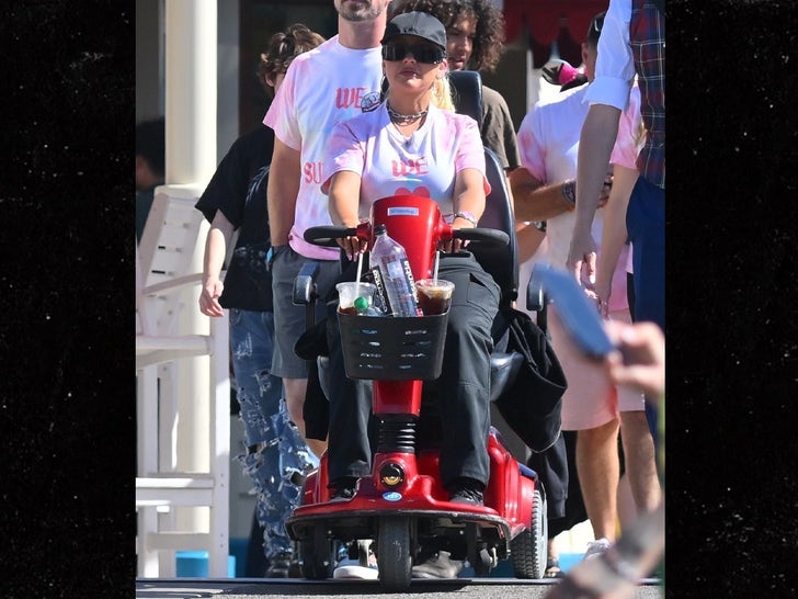 0817-Christina-Aguilera-Disneyland-Scooter-Rides-photos-primary-3