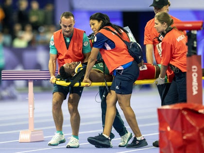 Lamecha Girma On a Stretcher After Falling At The Olympics