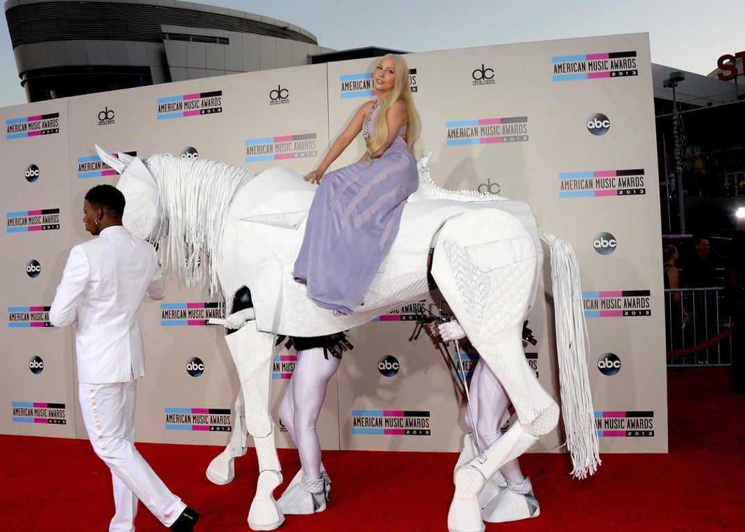Lady Gaga did what Lady Gaga does best: she showed up and made the red carpet her own personal stage. She busted in on a human powered white horse. This instantly set the tone for one of her most unforgettable award show appearances.