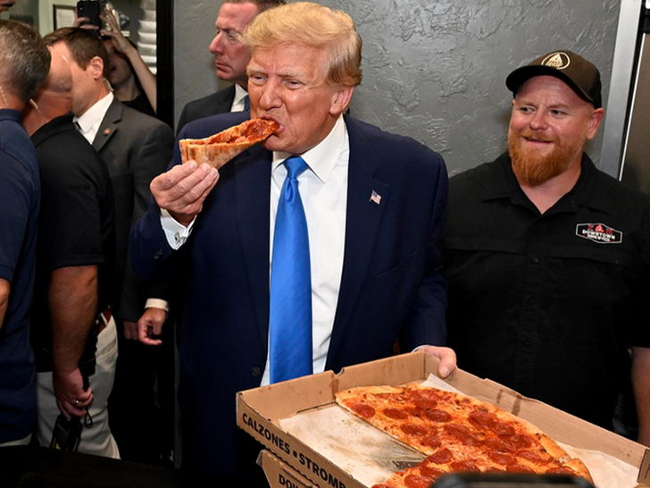 Former President Donald Trump eats a slice of pizza at Downtown