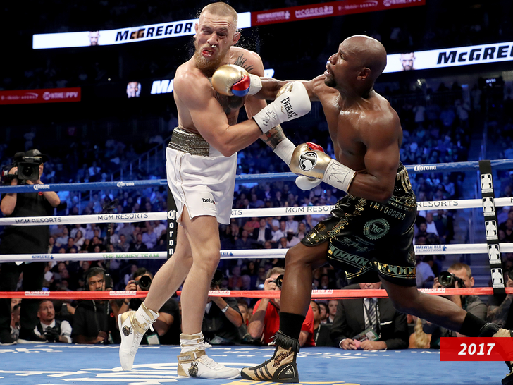 Floyd Mayweather Jr. throws a punch at Conor McGregor