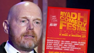 Bill Burr's looking concerned next to a poster for the Riyadh Comedy Festival. He's wearing a black tuxedo.