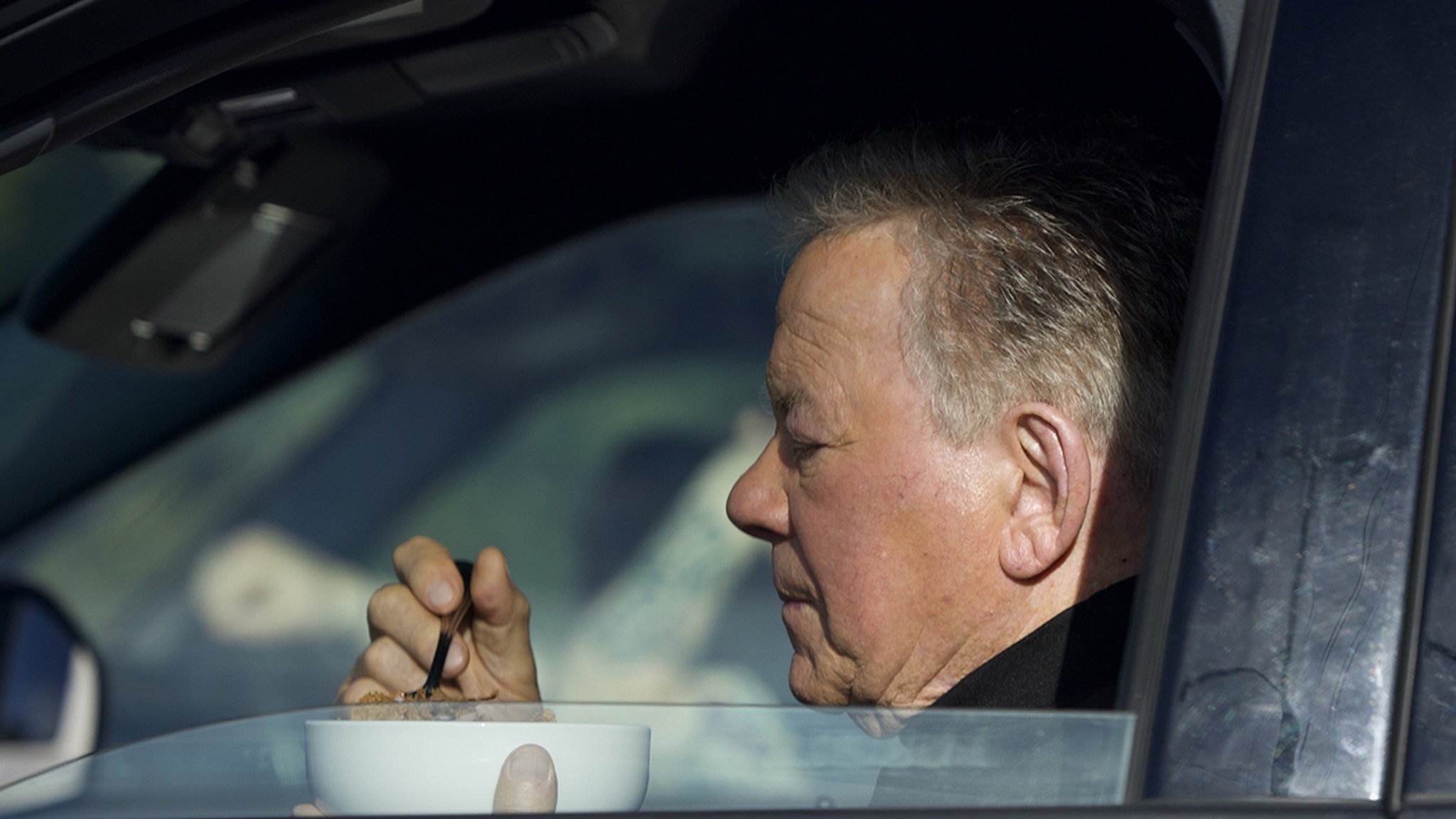 William Shatner Photographed Eating Bowl of Cereal in His Car at Stop Light