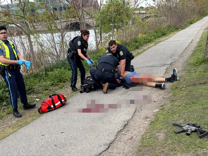 Man who had been seen shooting a weapon along Memorial Drive is treated by police officers in Cambridge reuters 1