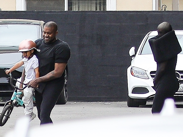 Kanye West plays with his son