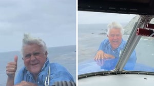 Jay Leno Hangs on Front of Airplane in Wild Video