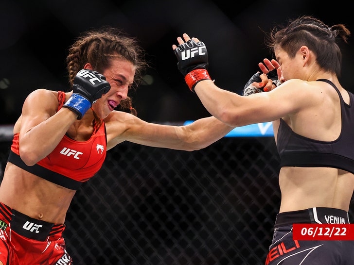 Joanna Jedrzejcyk of Poland exchanges strikes with Zhang Weili of China getty