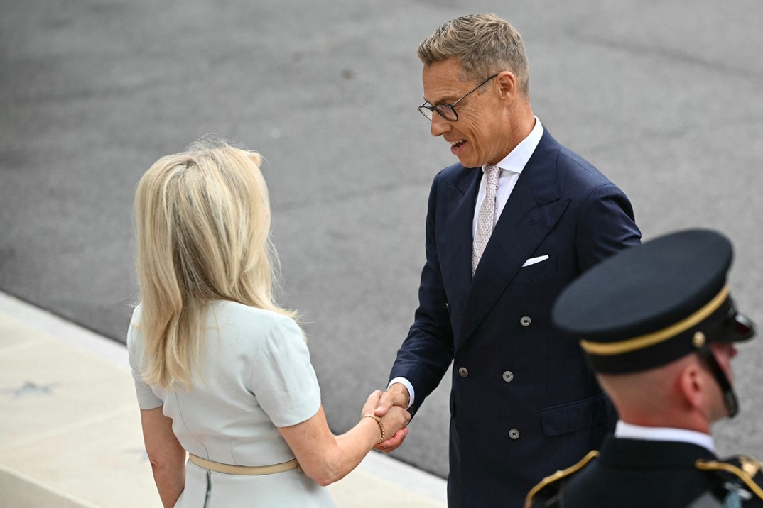 Finnish President Alexander Stubb is greeted by US Chief of Protocol Monica Crowley