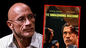 Dwayne Johnson is looking bummed out next to the poster of 