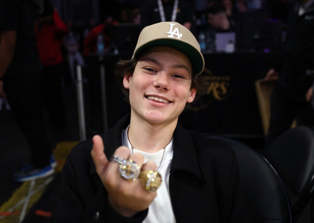 Maddox Batson flashes some Lakers championship rings while he watches the Los Angeles Lakers and Indiana Pacers at Crypto.com Arena on February 8, 2025 in Los Angeles