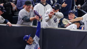 Yankees Fan Holding The Glove Of Mookie Betts During Game 4 Of The World Series