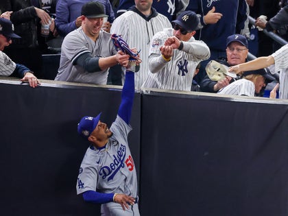 Yankees Fan Holding The Glove Of Mookie Betts During Game 4 Of The World Series