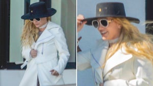 Britney Spears In A White Trench Coat And A Big Black Hat