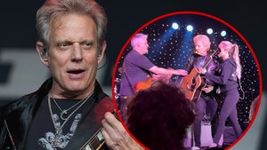 Don Felder being helped off stage
