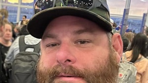 Syko Stu's seen in an apparent selfie. He's got a pair of sunglasses perched on the brim of his hat.