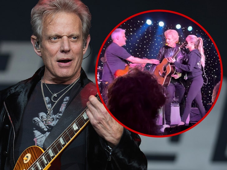 Don Felder being helped off stage