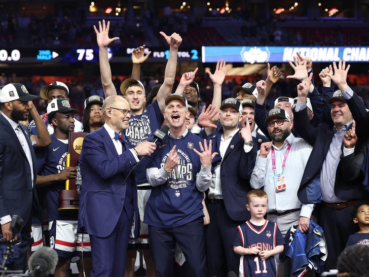 The Connecticut Huskies celebrate with the trophy