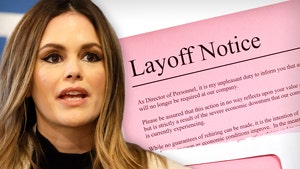 Rachel Bilson's looking concerned in front of a layoff notice. She's wearing a black sheer top and a white coat.