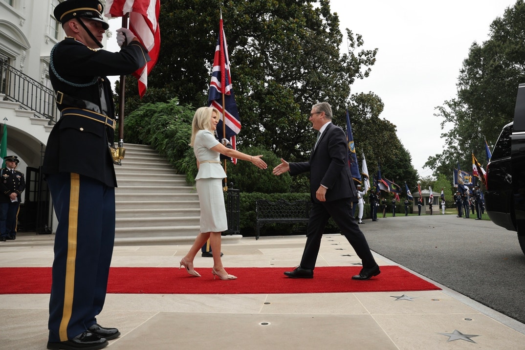 British Prime Minister Keir Starmer (R) is greeted by U.S. Chief of Protocol Monica Crowley as he arrives at the White House
