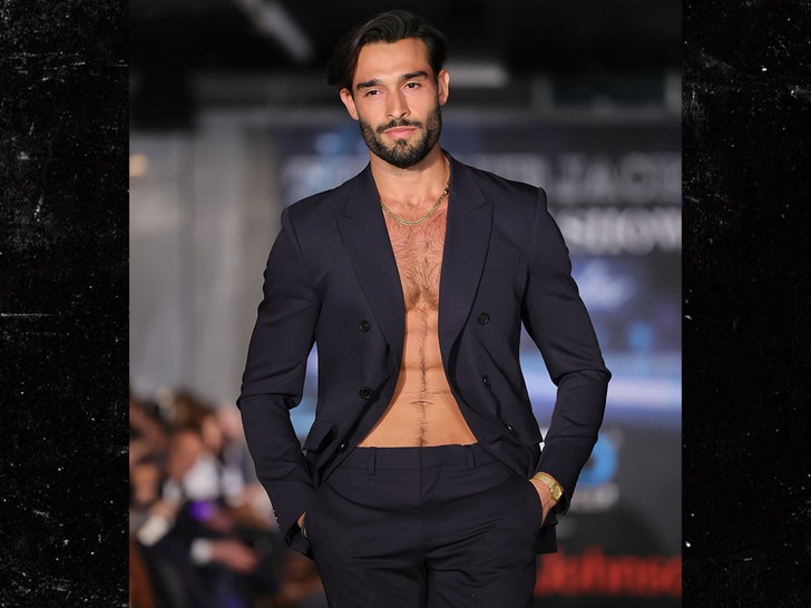 Sam Asghari walks the runway for the Blue Jacket Fashion Show getty