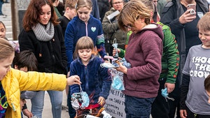 Idaho's #BurnTheMask Rally Sees Kids Tossing Face Masks Into Fire