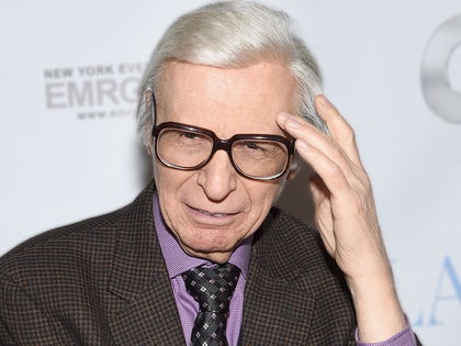 The Amazing Kreskin WEaring Glasses And Holding His Hand To His Head