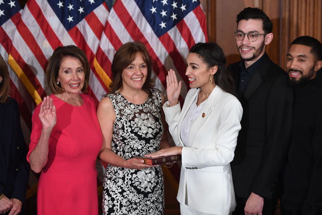 Speaker of the House Nancy Pelosi (L) the ceremonial swearing-in of Rep. Alexandria Ocasio-Cortez (3rd-R), D-NY, at the start of the 116th Congress at the US Capitol in Washington, DC, January 3, 2019.
