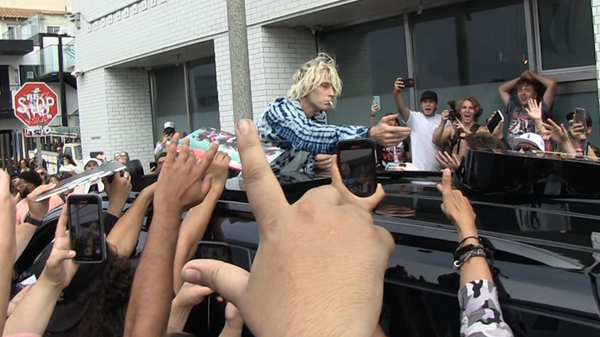 Machine Gun Kelly Swarmed by Fans After Rooftop Performance
