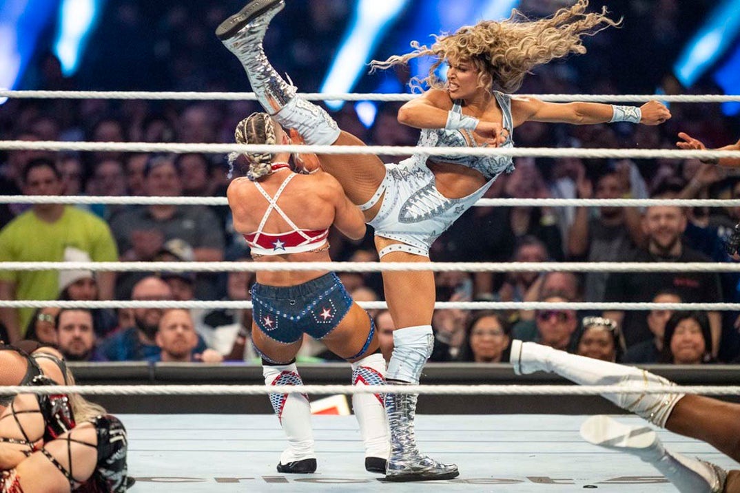 Maxxine Dupri delivers a spinning heel kick to her opponent.