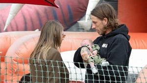 Frances Bean Cobain And Riley Hawk With Their Baby