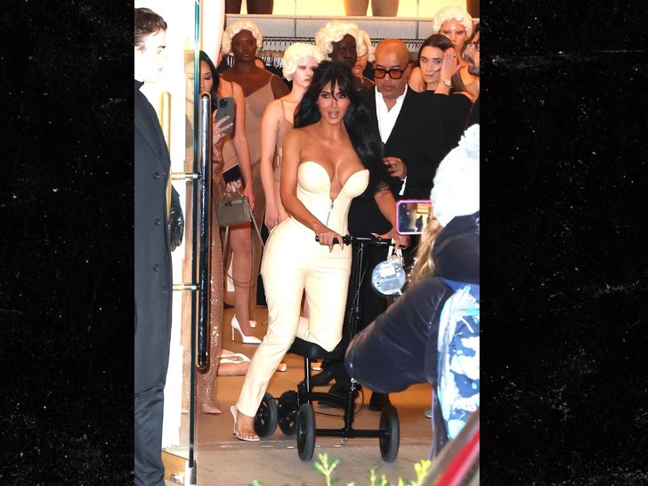 Kim Kardashian using a scooter