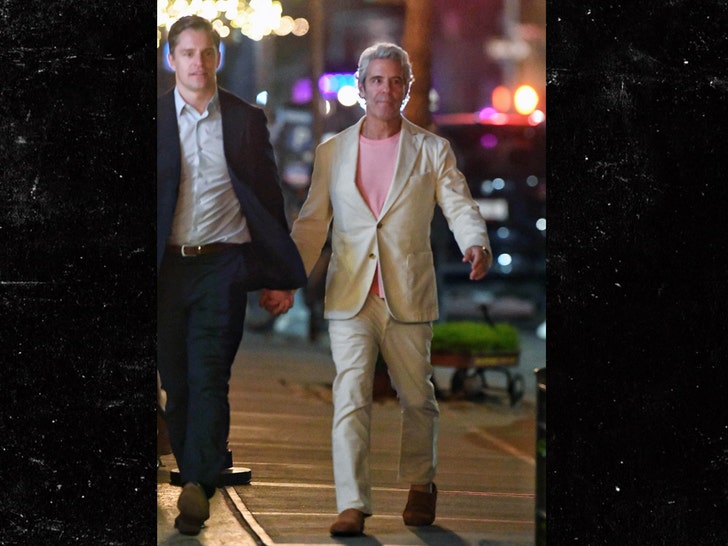 Andy Cohen holds hands with guy in NYC image direct