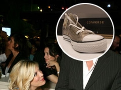 Tori Spelling and Dean McDermott with a sneaker for a head